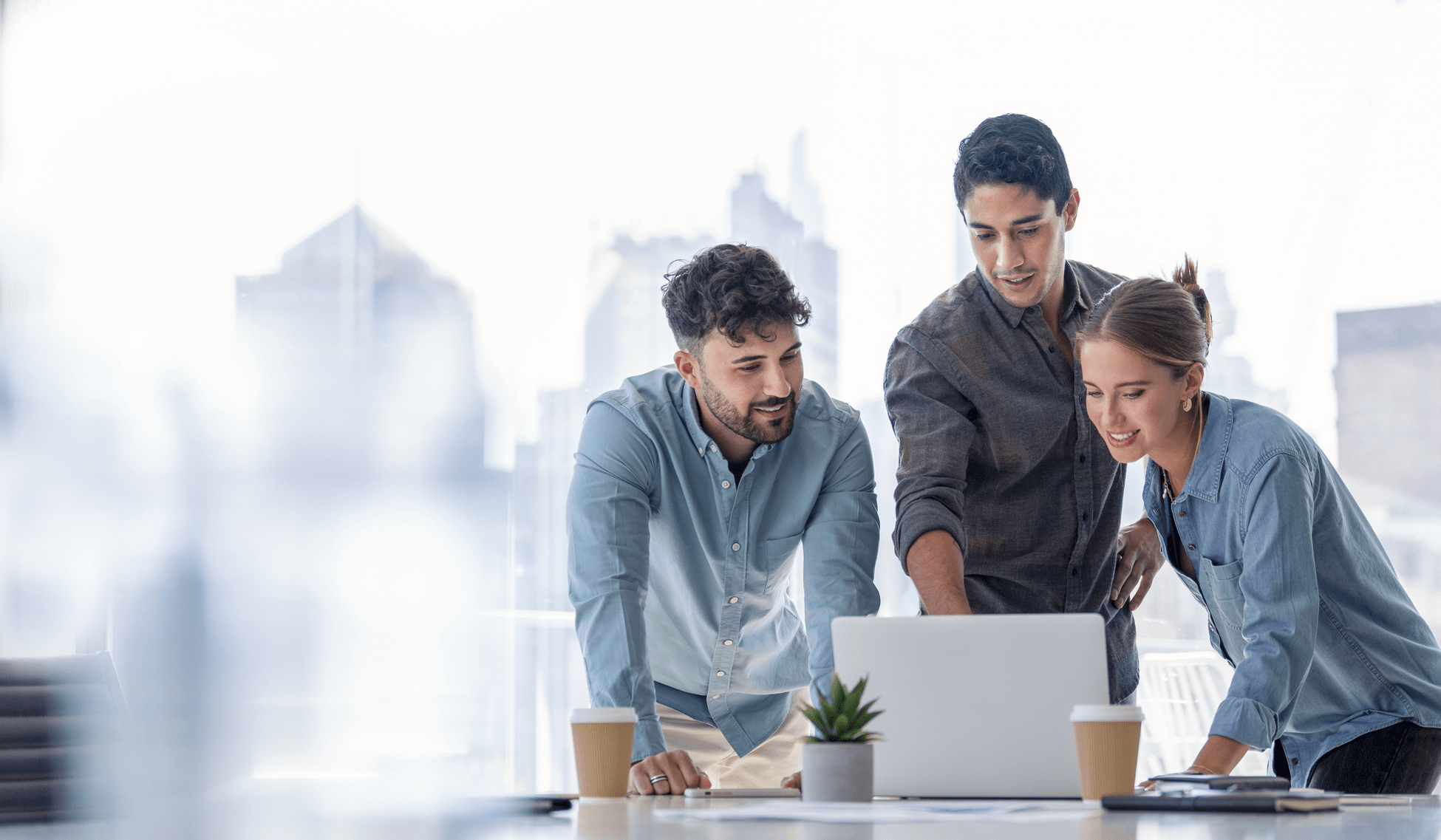 HOA professionals collaborating in a modern workspace, reviewing documents and taking action together. using Smartwebs HOA Accounting Automation Software Solution